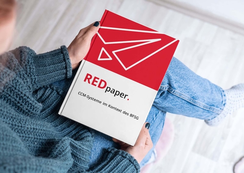 Mujer con un libro en el regazo citando "CCM systems in the context of the BFSG"